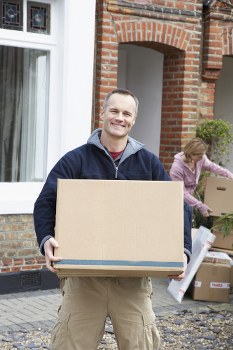 Movers working on a residential move in Bow with boxes and furniture