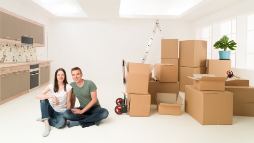 Professional movers carrying furniture in Bow