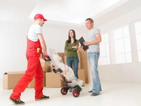 Loading furniture into a van for a Bow relocation job