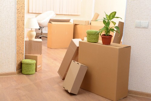 Movers handling furniture and boxes in an East London property